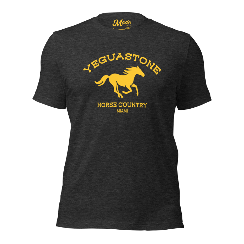 Front view of the Yeguastone T-Shirt in dark heather grey, featuring a bold yellow horse graphic with “Yeguastone” arched above and “Horse Country Miami” below. A modern nod to Cuban cowboys and the unique blend of Western and Latin culture in Miami.